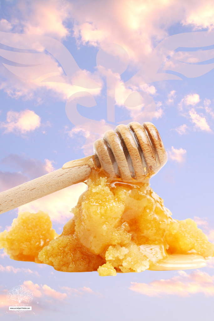 Photo of honey calcite with honey on top in front of a cloud backdrop. 