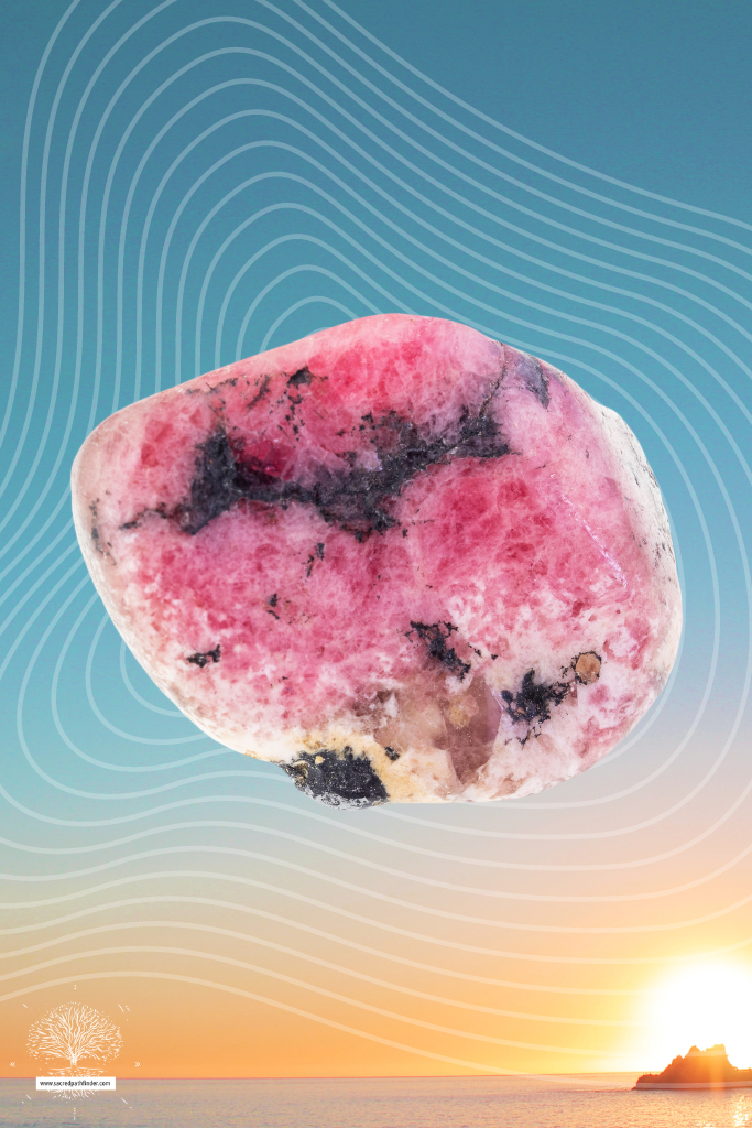 Photo of rhodonite in front of a sunset background.
