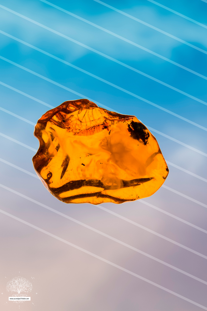 Photo of an amber stone in front of a sky background. 