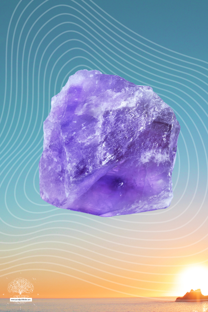 Photo of an amethyst crystal in front of a sunset background.