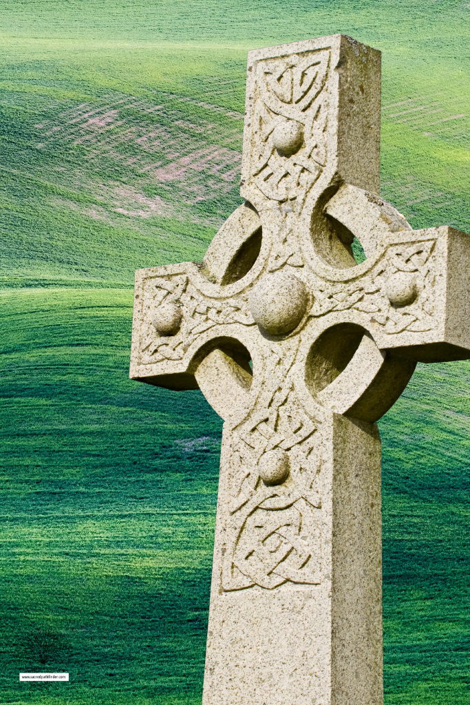 Photo of a Celtic Cross grave stone in front of a grassy background. 