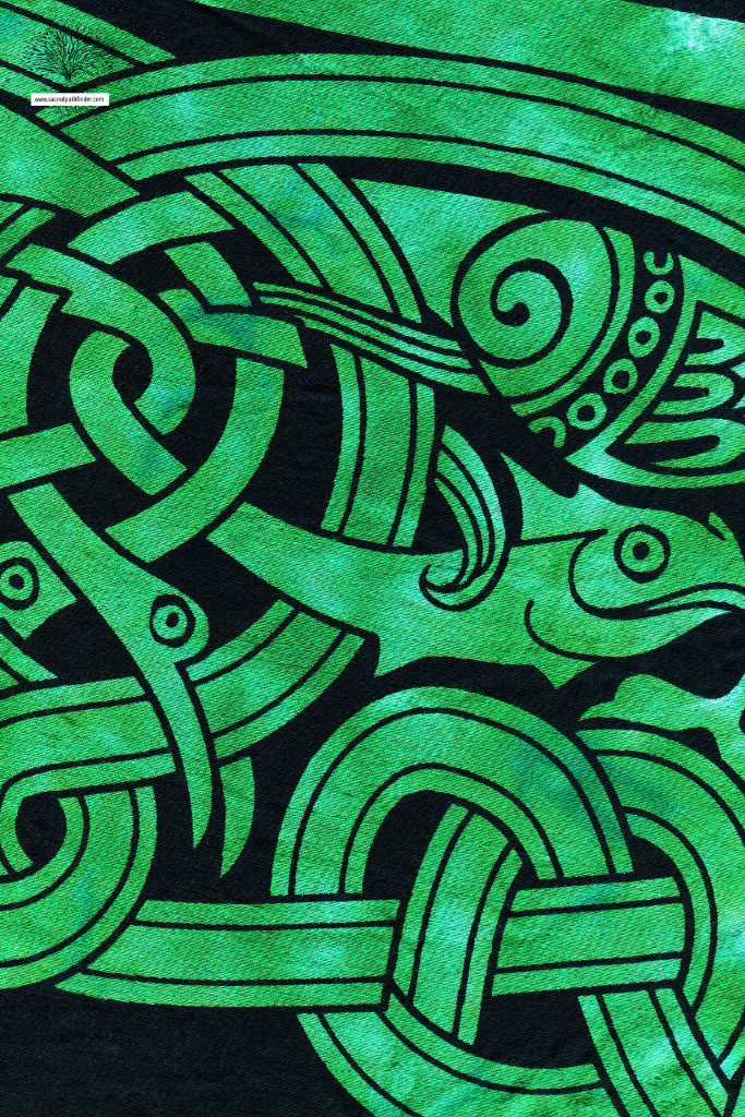 Closeup photo of black and green art work that is celtic symbols. 