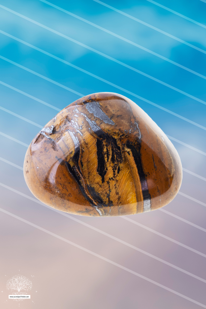 Photo of a polished tiger's eye stone in front of a sky background. 