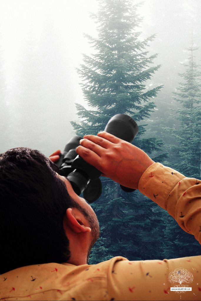 Photo of a man bird watching in front of a forest background