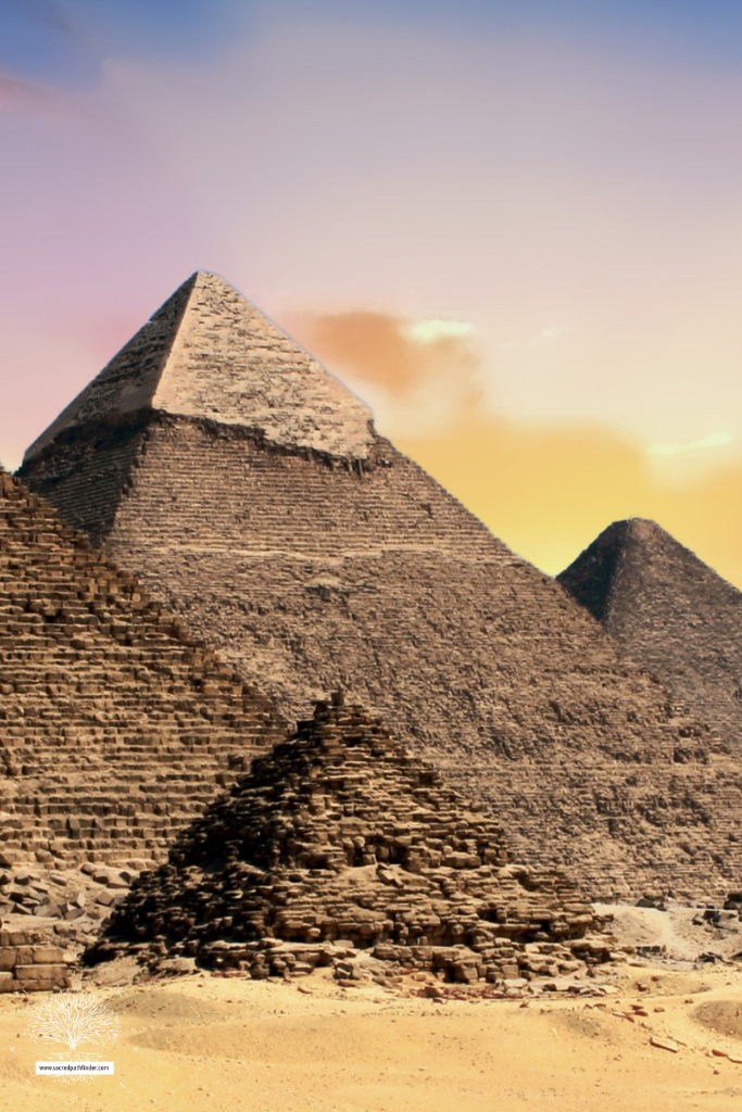 Photo of the egyptian pyramids in front of a sunset