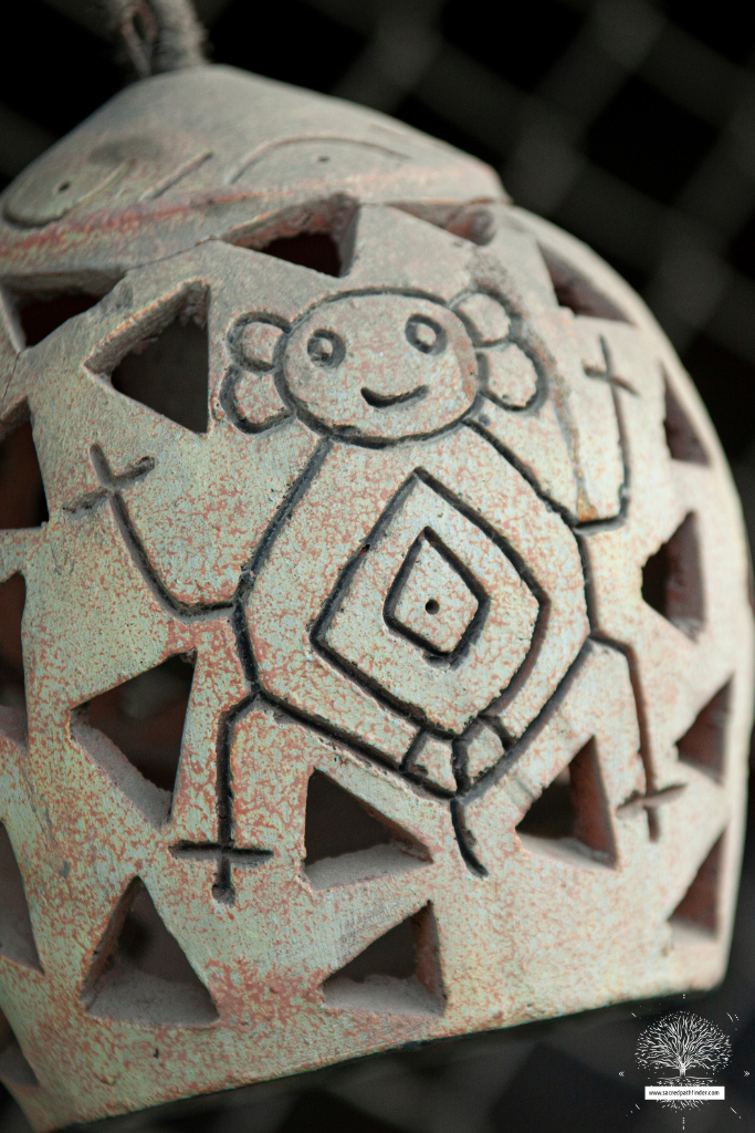 Closeup photo of a Taino symbol on pottery. 