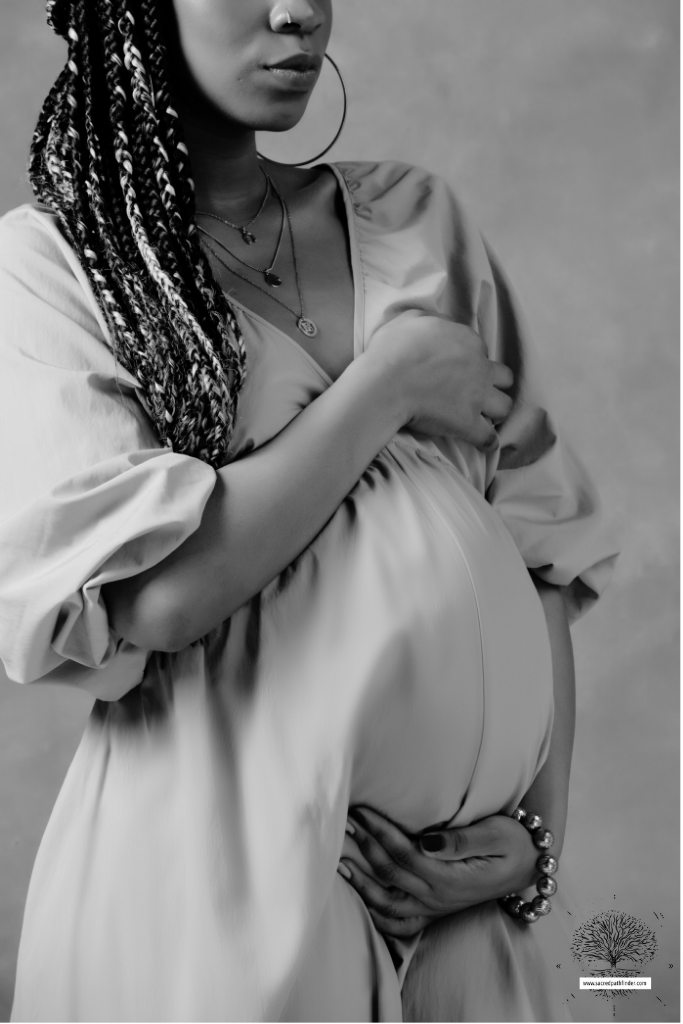 Photo of a woman, showing off her pregnant belly in a beautiful dress.