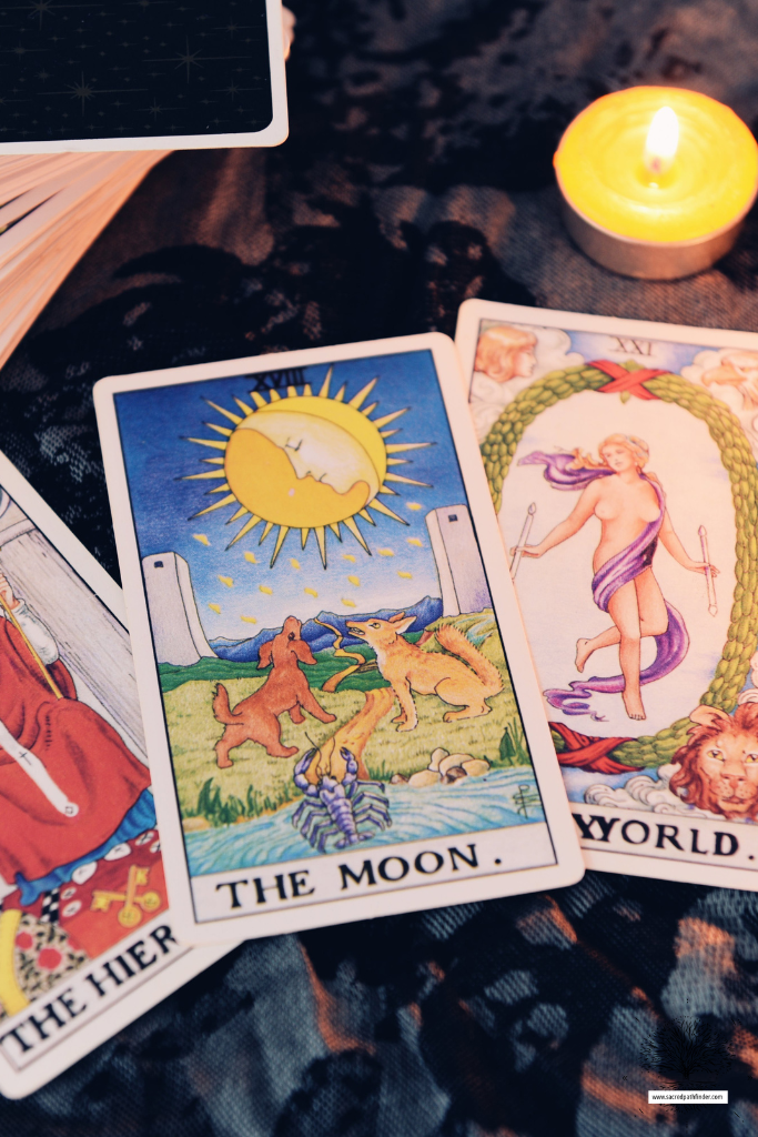 Photo of a closeup of tarot cards. The moon card is front and center. 