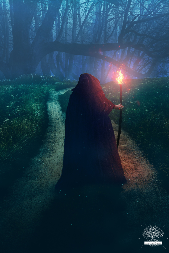 Photo of a person with a red cloak. She is holding a torch and walking on a dark path in a forest. 